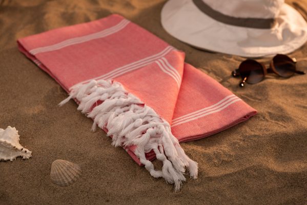 Handwoven hammam Turkish cotton towel on beach