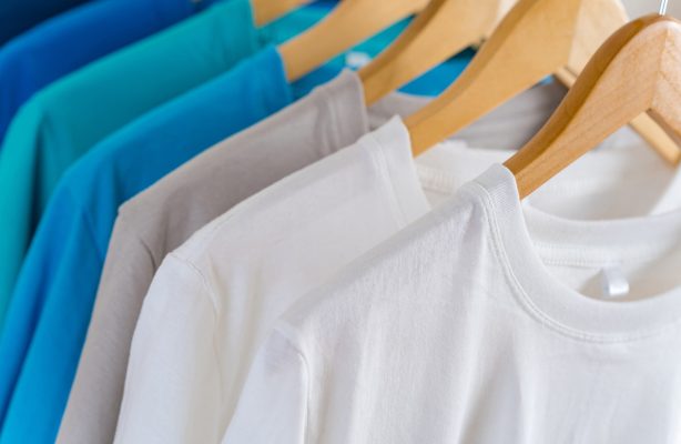 Close up of Colorful t-shirts on hangers, apparel background