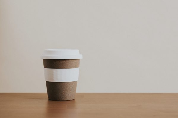 Cork reusable coffee cup on wooden table