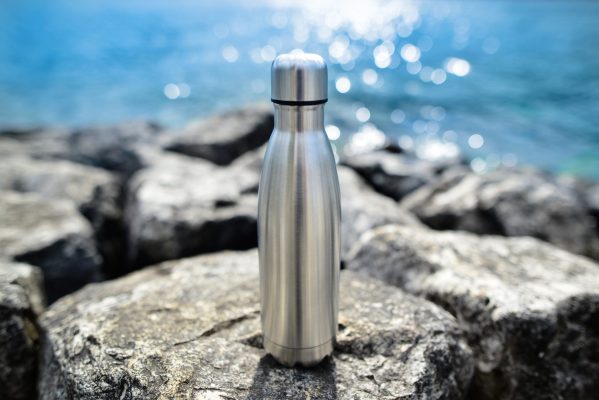 steel-eco-thermo-water-bottle-on-the-background-of-the-lake-be-plastic-free-zero-waste-copy-space