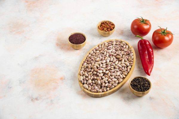 Vertical photo of Pile of Beans with various kinds of spices and fresh tomatoes. High quality photo
